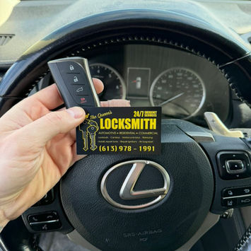 Locksmith business card and car key in a Lexus vehicle