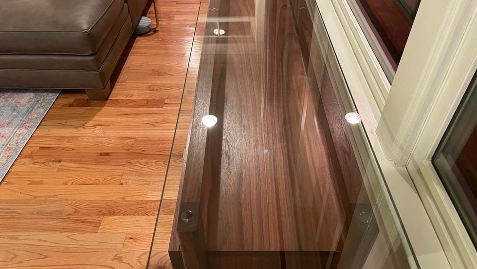 The Laurent console table in walnut Glass top closeup