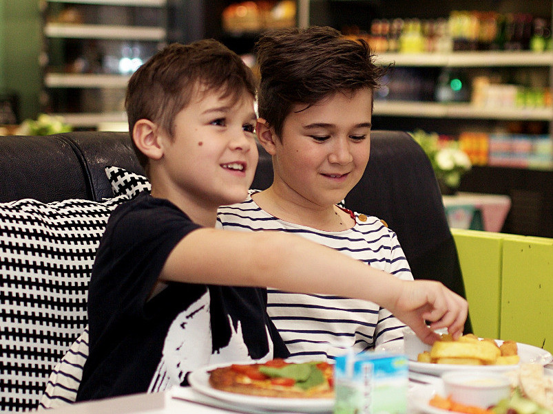 Boys eating children's pizza in family restaurant at Head Over Heels