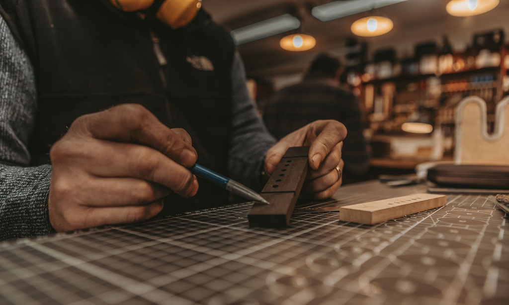 Scraping down the binding on an acoustic guitar build.