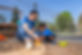 Volunteer playing with child in the sand