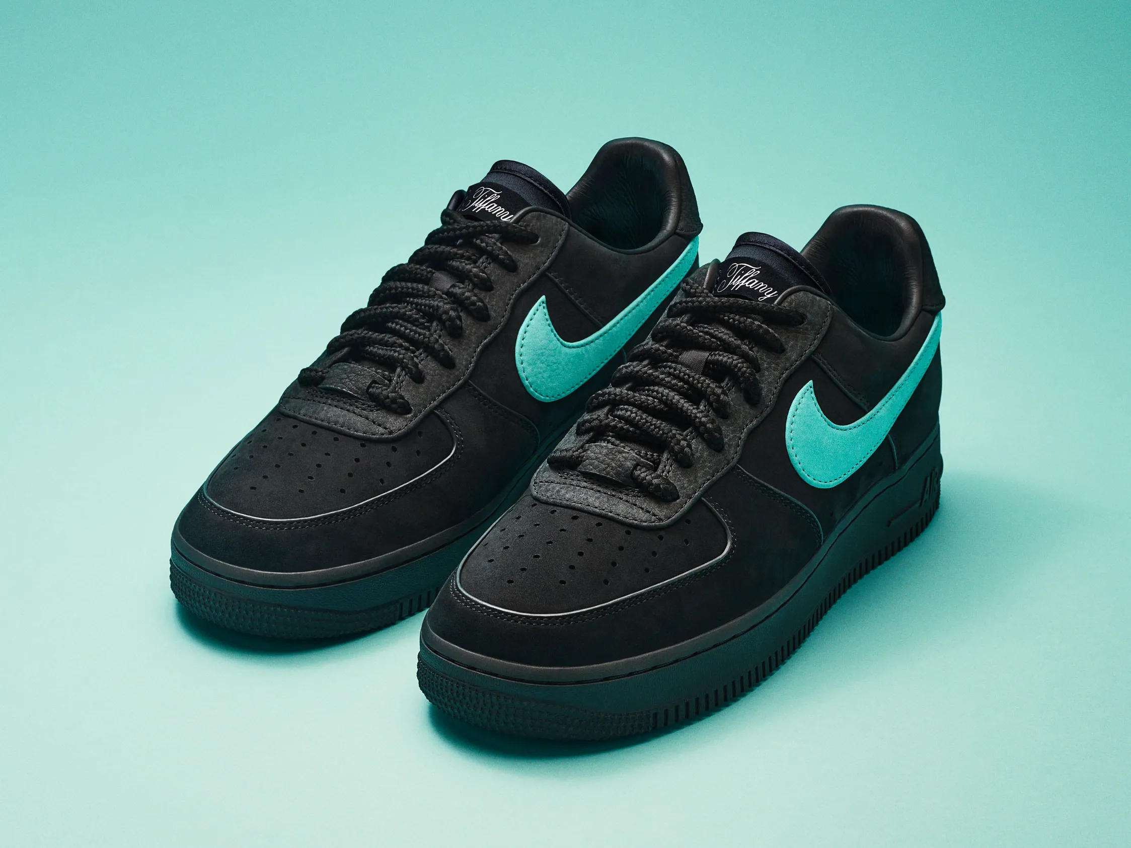 A full look at the Nike x Tiffany & Co. Air Force 1 1837. A sleek black suede sneaker with a splash of Tiffany Blue®, proving that sometimes hype overshadows innovation.