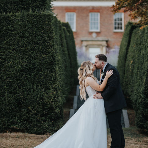 Bride and groom sharing an intimate moment on the castle grounds at Hedingham Castle