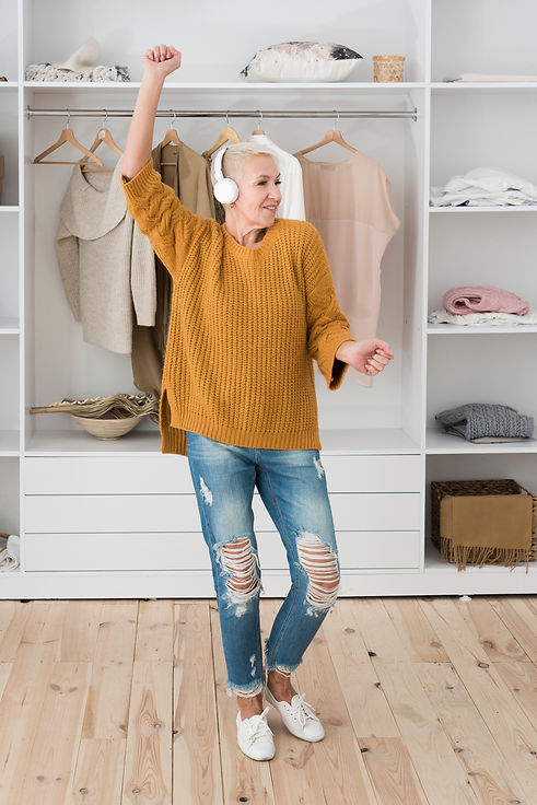 happy-elderly-woman-dancing-while-listening-music-headphones.jpg