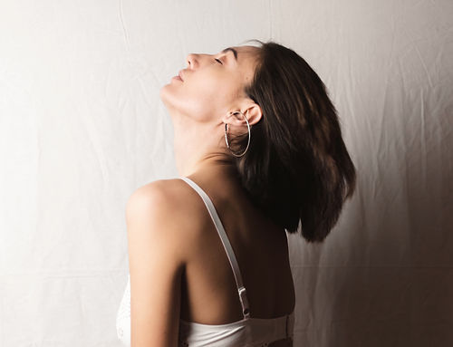 gentle-portrait-beautiful-young-woman-with-big-breasts-beige-suit-white-lace-bra-gray-whit