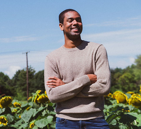 man smiling while taking photo near the sunflower_edited.jpg