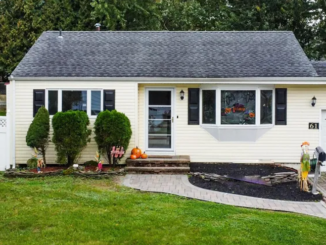 One of our sold properties: a yellow ranch-style home.