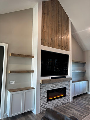 Modern living room with fireplace, TV, shelves, and wooden paneling Home design.
