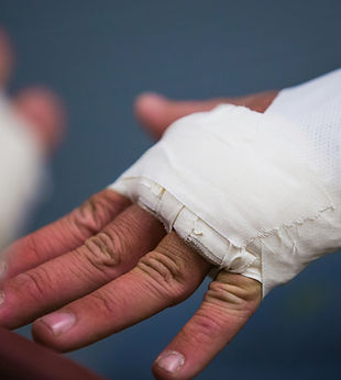 Close-up of a bandaged hand receiving medical treatment. Highlights Kalin Law, PLLC’s personal injury law services for accident victims seeking compensation.