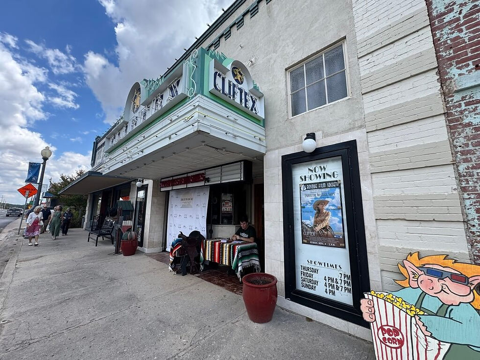The exterior of the Cliftex Theater showcasing "Under the Western Skies" movie poster in the marquee.