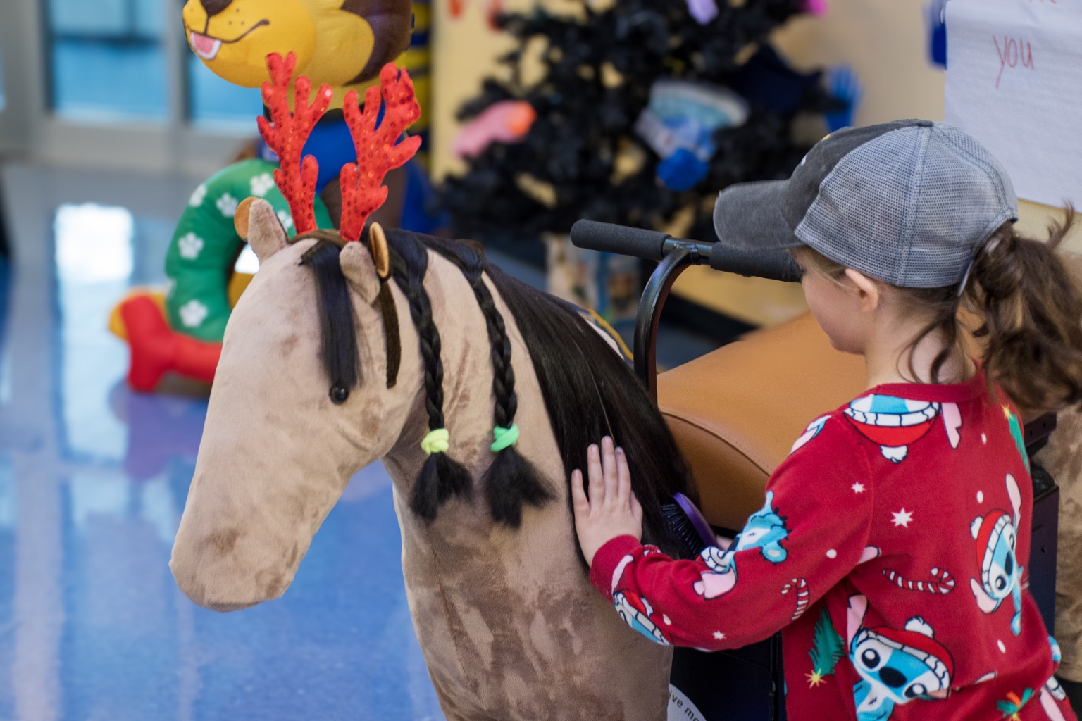 Participant interacting with the Mane Motions MiraColt mechanical horse