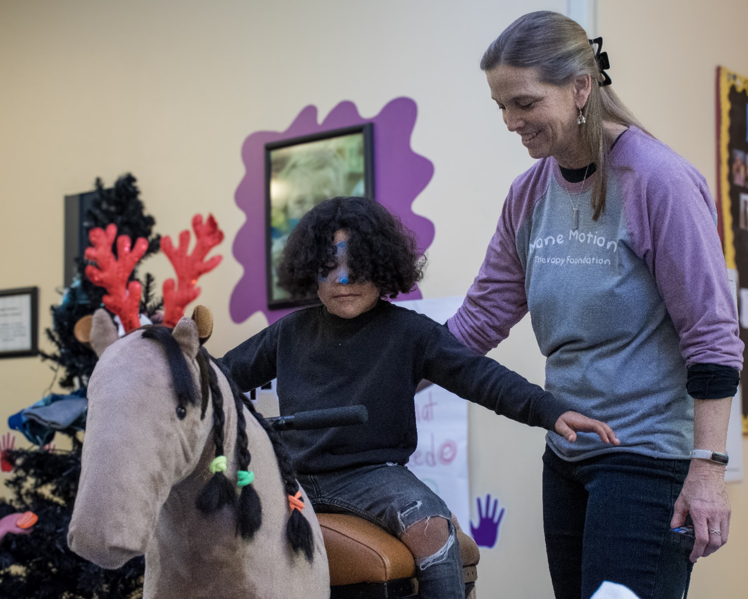 Participant with Mane Motions mechanical horse