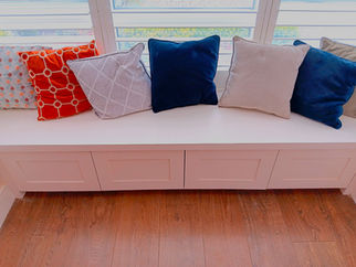 Custom living room built in window seat with storage in white