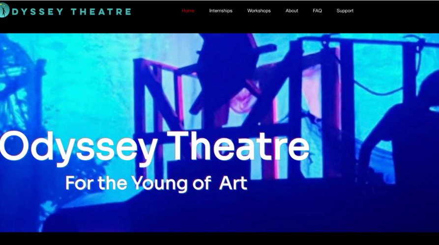 Blue theatrical lightinng with stagehands changing a set