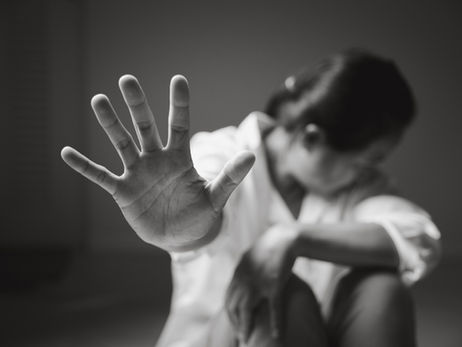 A woman with her hand in front of her body saying "NO!"