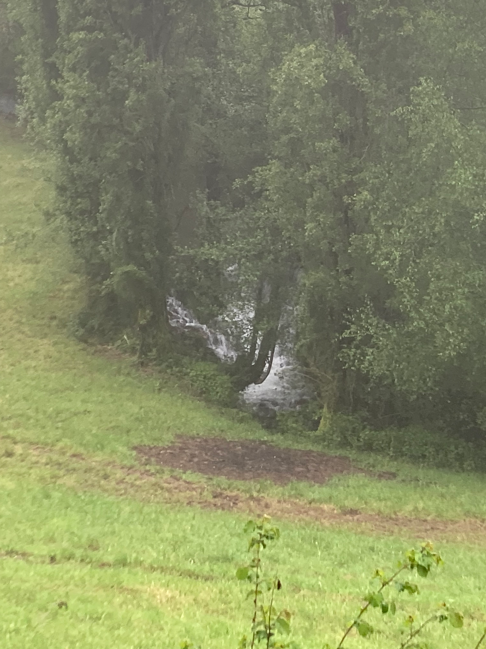 A river and waterfall down off the trail