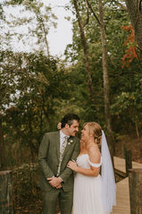 Annapolis bride and groom smiling at each other during portraits on a dock at Annapolis Maritime Park