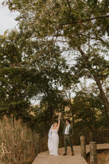 Annapolis bride and groom smiling at each other and twirling during portraits on a dock at Annapolis Maritime Park