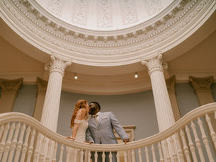 Couple kissing at the Walters Art Museum spiral staircase