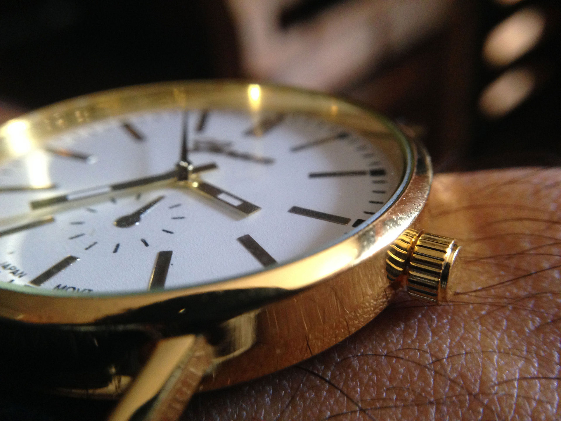 gold watch with a white face