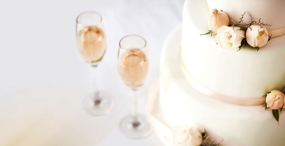 Wedding Cake And Champagne Flutes On Table_edited.jpg