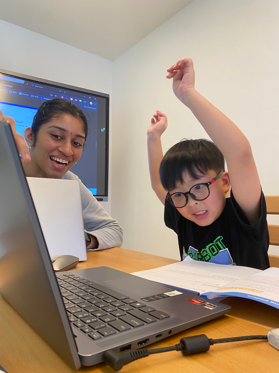 Excited student and mentor at a kids coding competition.