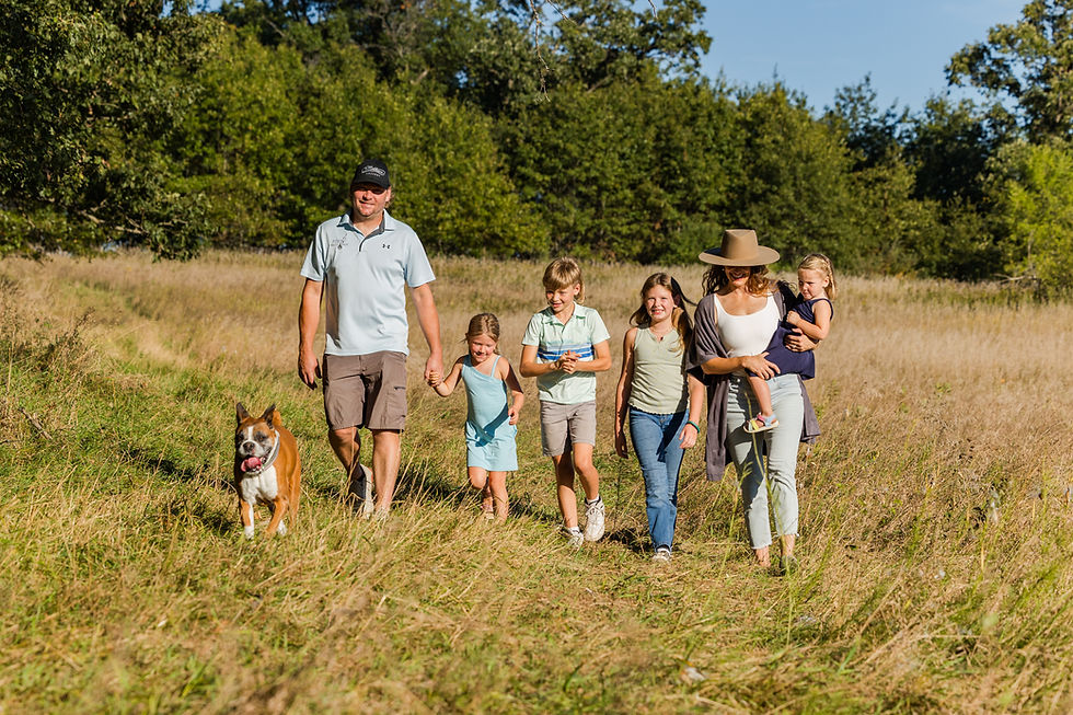 Photo of Roo and her family walking through an open field