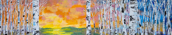 White birch trees frame a glowing orange and yellow sunset reflected across calm water.