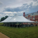 60x90 Pole Tent with round tables and white wooden folding chairs