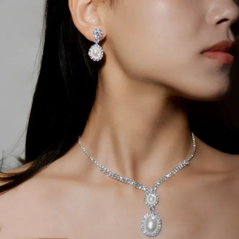 Thumbnail: Jade Lion Ivory Oval Pearls AB Silver Rhinestone Necklace and Earrings Set