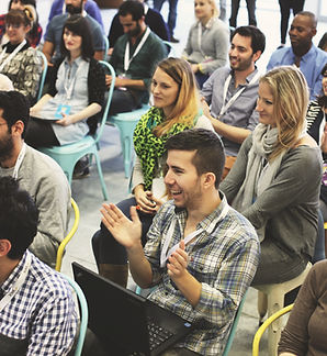 Conference attendees listening to a speaker