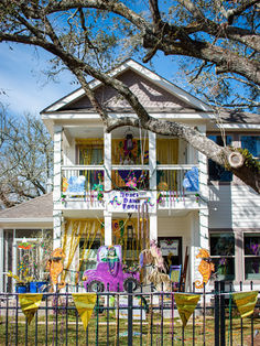 Mardi Gras house with Laissez les bons temps rouler sign, festive decorations.