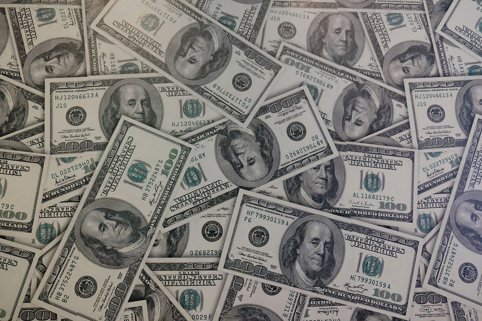 A pile of 100 dollar bills. Value of consumer research.