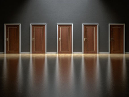A row of doors in a room.  Choosing the right research approach.