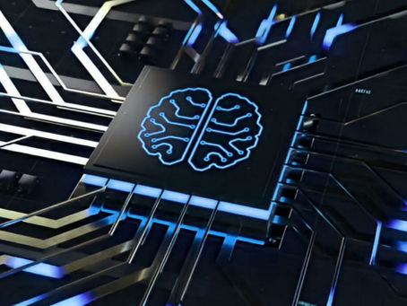 A close-up photograph of a microchip with a glowing blue brain icon on its surface, symbolizing artificial intelligence. Black circuit lines radiate outward from the chip, highlighting connections and data flow in a high-tech electronic system. AI for brand positioning.