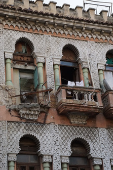 An apartment building succumbs to time and the elements. Havana, Cuba