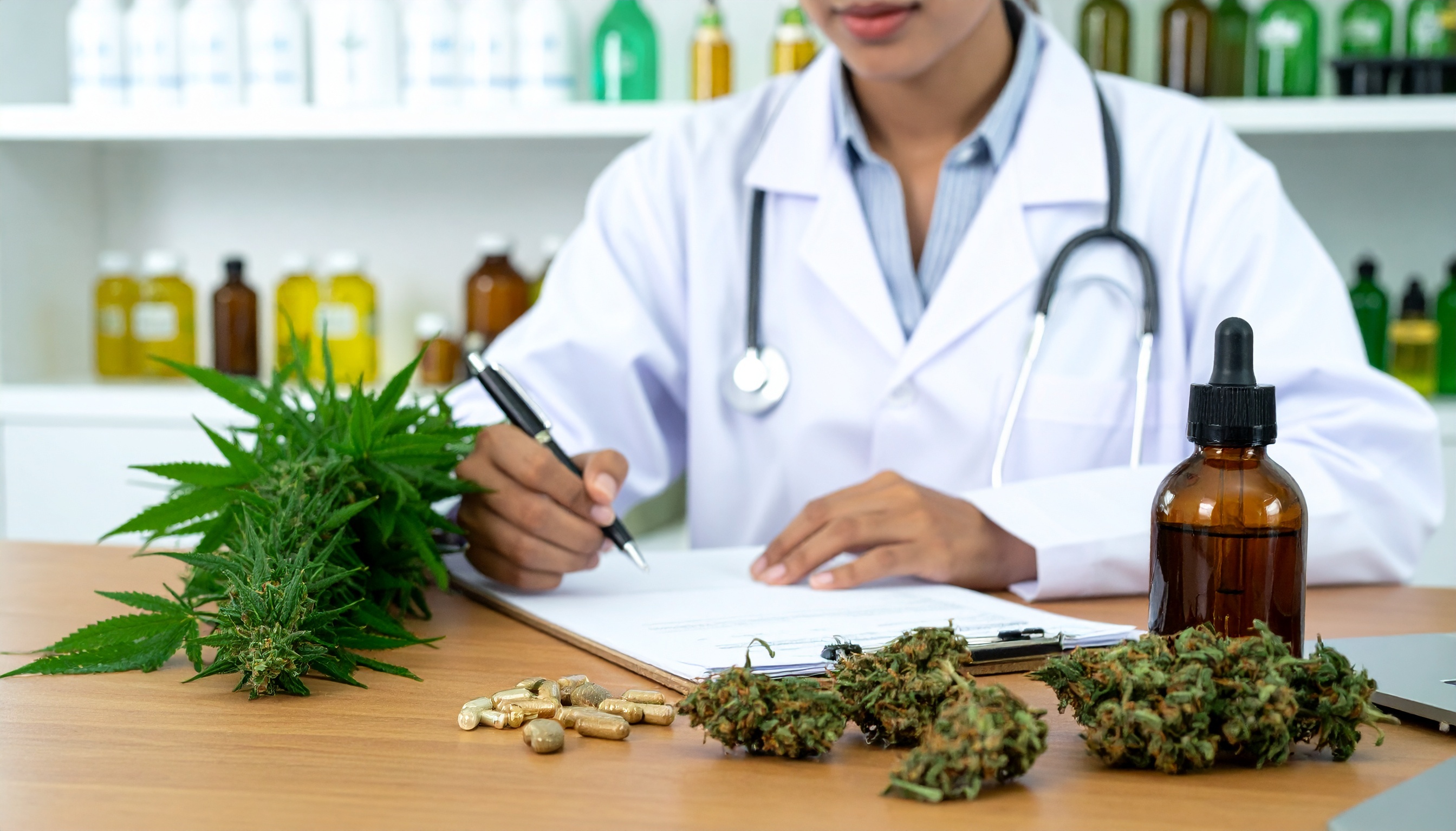 Clinician writing notes beside medical cannabis products