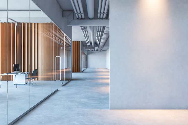 Modern office interior with glass walls and concrete floor