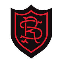 The Rougemont school crest, which is a shield shape, with a red R and S interwoven.