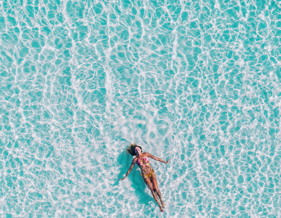 woman floating on her back in a pool
