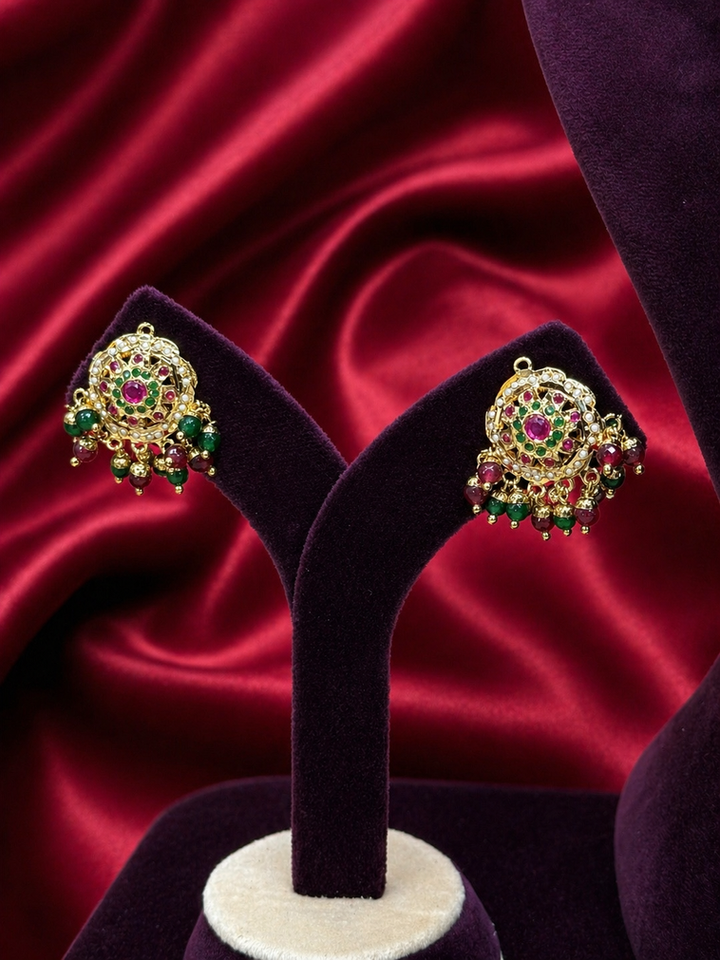Jadau gold earrings with red and green gems
