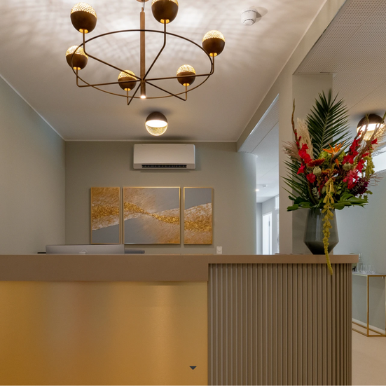 a reception desk with a vase of flowers on it