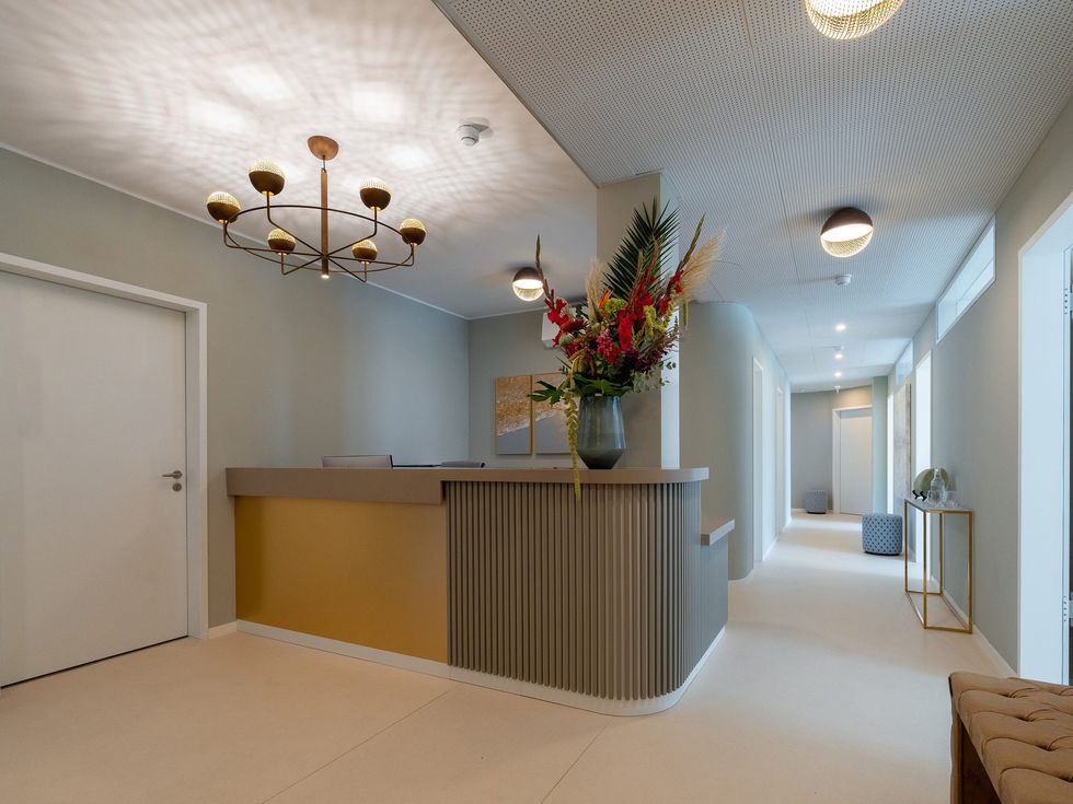 a reception desk with a vase of flowers on it