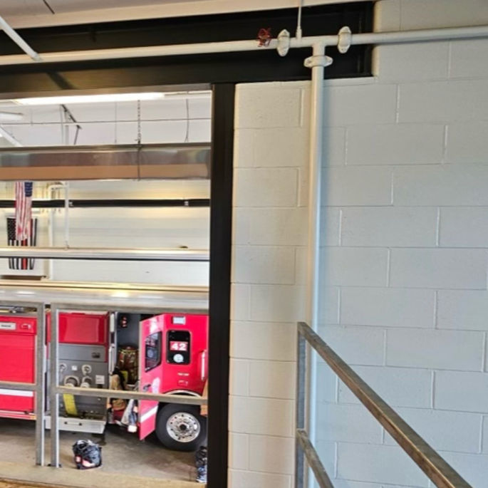 Red fire truck inside a fire station bay