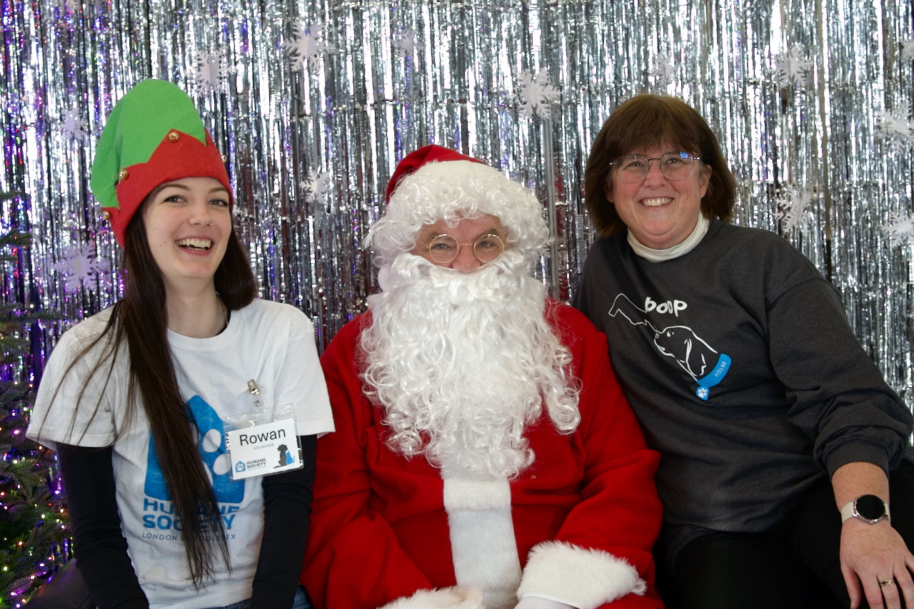 xcited Humane Society London & Middlesex volunteers getting their picture taken with Santa during Winter Wonderland event in London, Ontario