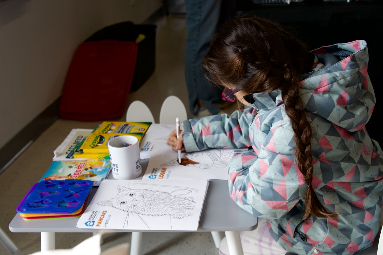 At the coloring corner, a little girl sat quietly absorbed in her artwork adding her own splash of color to the Winter Wonderland experience