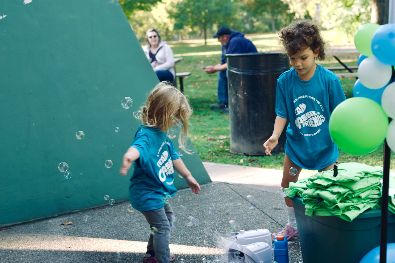 Kids enjoying Cassie & Friends walk event in London, Ontario at Springbank Park, playing with bubbles during a fun spring outing