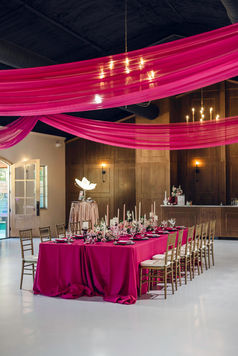 a beautifully dressed king table in shades of pink sits in the Dorcas Ann Hall. The reception hall at hidden creek at stonehaus
