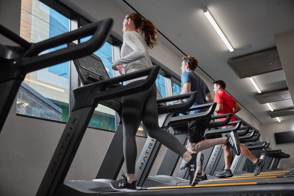 MX23_LIFESTYLE_HOSP DC female-males treadmills running lo-angle.jpg