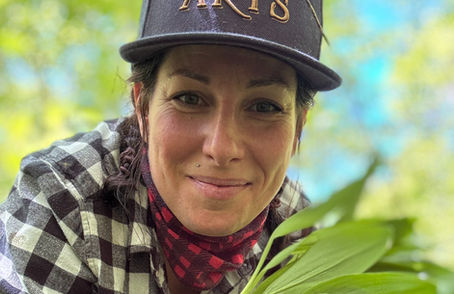 Mel smiling holding ramps in the forest